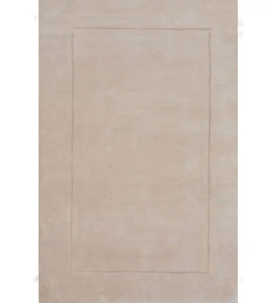 Solid beige minimalist hand-tufted rug with subtle rectangular border design