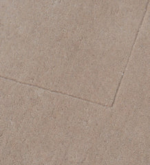 Luxury solid hand-tufted wool rug with soft beige tone