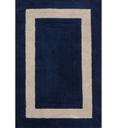 Navy blue hand tufted rug with beige border