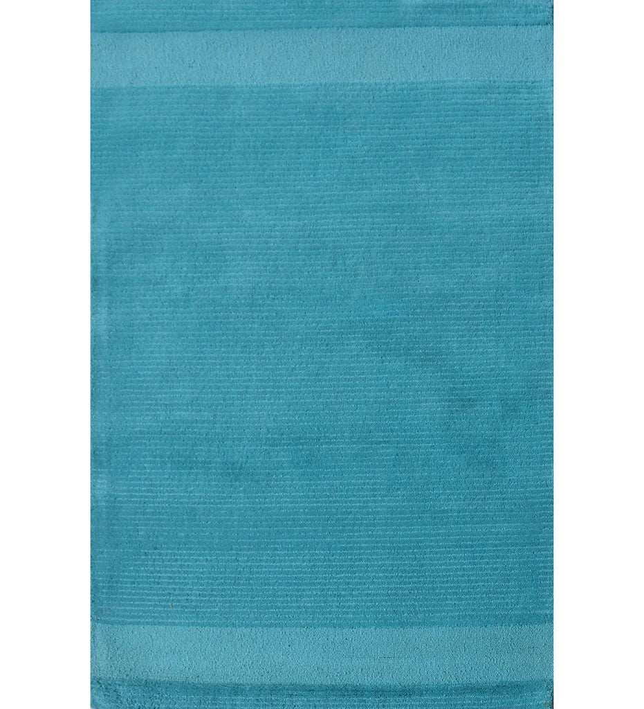 Solid teal hand-tufted wool rug with minimalist linear design