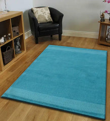 Modern teal rug featuring subtle linear texture pattern