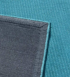 Minimalist solid teal rug with linear handcrafted detailing