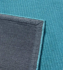 Minimalist solid teal rug with linear handcrafted detailing