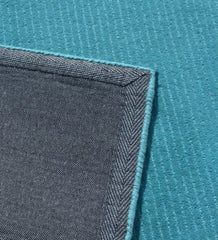 Minimalist solid teal rug with linear handcrafted detailing