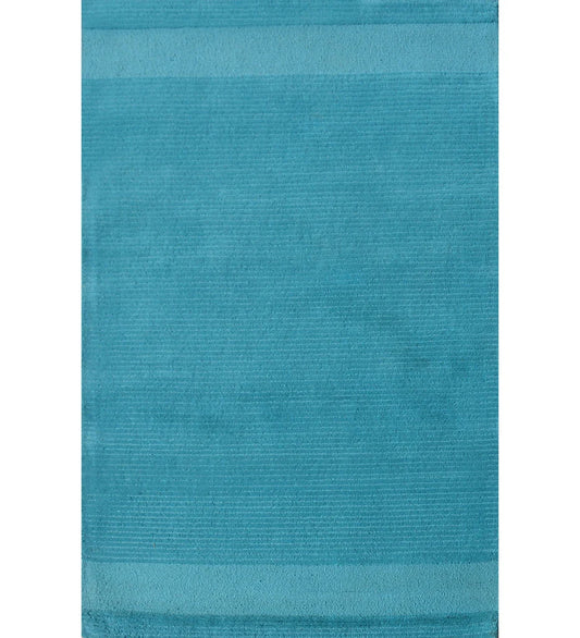 Solid teal hand-tufted wool rug with minimalist linear design
