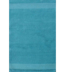 Solid teal hand-tufted wool rug with minimalist linear design