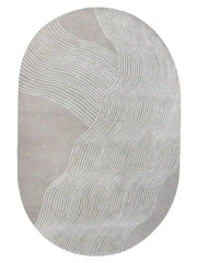 Taupe and white hand-tufted oval wool rug with modern wavy line design.