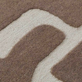 Close-up of luxury handwoven taupe and cream abstract pattern rug with textured fiber