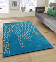 Modern artisan wool rug featuring teal base with abstract dots