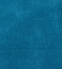 Modern solid teal rug featuring bordered design detail