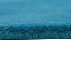 Minimalist teal wool rug with clean border pattern