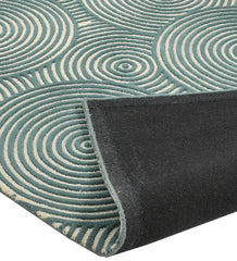 Handcrafted teal and ivory rug with artistic circular motifs