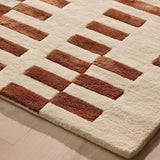Terracotta and cream modern geometric patterned handwoven rug on light hardwood floor