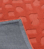 Handcrafted wool rug in terracotta orange with embossed texture