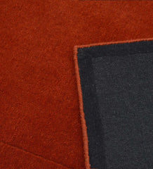 Handcrafted wool rug in terracotta orange minimalist style