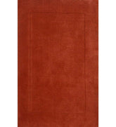 Solid terracotta orange hand-tufted wool rug with embossed rectangle