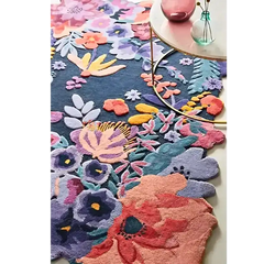 Luxury floral handwoven rug in vibrant colors under a round glass table with decorative vases