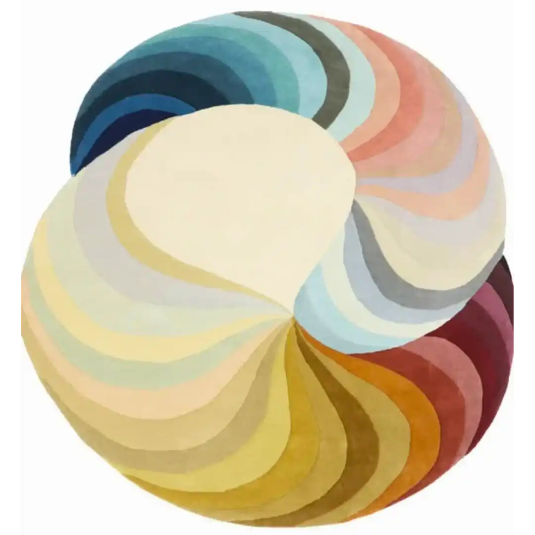 Round luxury handwoven rug with swirling gradient segments in blues, pinks, yellows, and browns