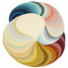 Round luxury handwoven rug with swirling gradient segments in blues, pinks, yellows, and browns