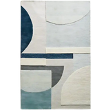 Modern luxury rug with geometric shapes in blue, gray, and white hues, handwoven texture