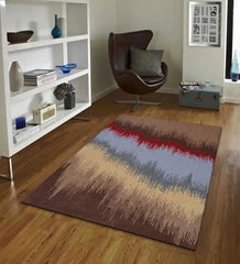 Modern living room with abstract wave pattern rug in brown, blue, red, and beige tones, next to a brown leather chair