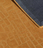 Modern hand-tufted rug in golden tones with embossed detailing