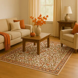 Cozy living room with beige sofa and armchair, wooden coffee table, warm botanical patterned rug, and autumn-themed decor