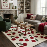 Living room with cherry-themed rug, gray sofa, and wooden coffee table.