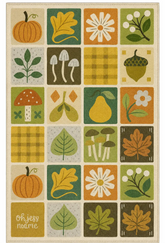 A square area rug with a retro autumn-themed grid pattern featuring illustrations of pumpkins, leaves, daisies, mushrooms, acorns, pears, and plaid squares in muted orange, green, yellow, and beige tones.