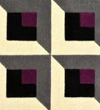 Geometric pattern with squares in black, purple, and gray on a textured surface.