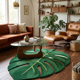 Living room with a green leaf-shaped rug, brown sofa, and bookshelf.