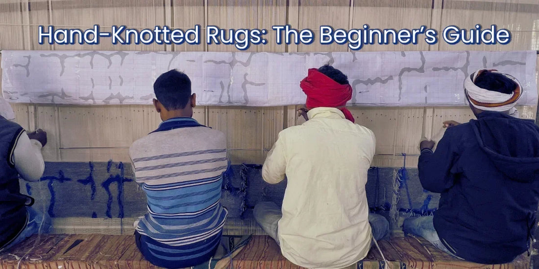 Four artisans hand-knotting a rug on a loom, crafting traditional hand-knotted rugs indoors