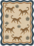 A square area rug featuring a safari theme with five walking cheetahs and palm fronds. The rug has a beige background, brown double-line border, a dark blue scalloped outer border, and the cheetahs are tan with black spots.