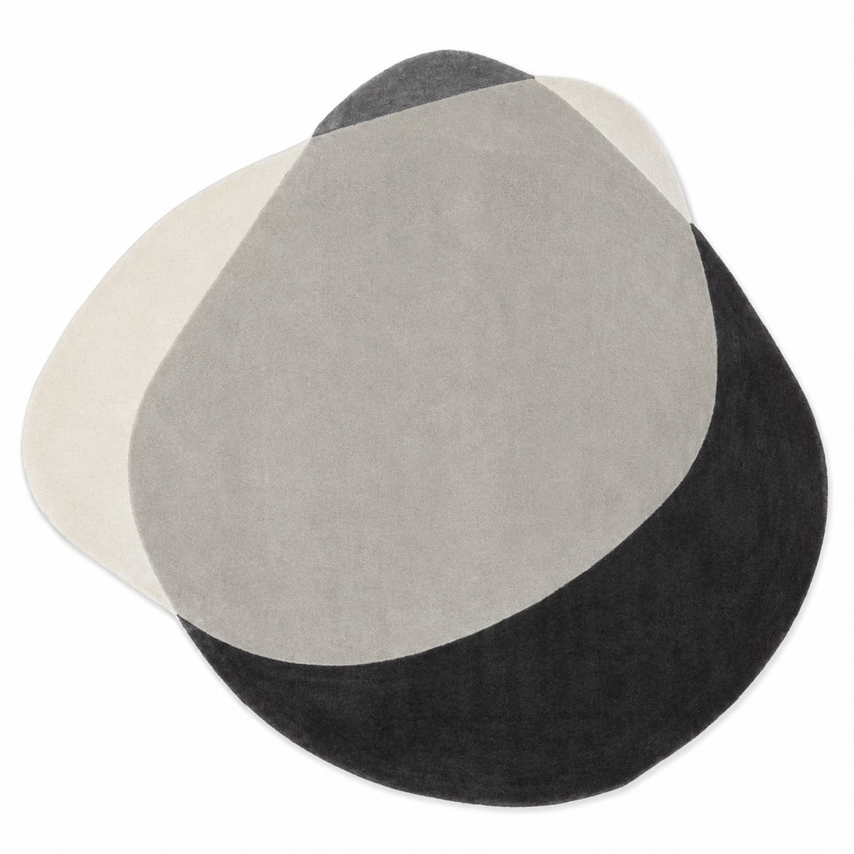A modern abstract oval rug with a three-tone color-blocked design in cream, light gray, and black, shown on a plain white background.