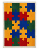 A rectangular area rug featuring a colorful jigsaw puzzle pattern with alternating blocks of red, blue, green, and yellow, finished with a light beige border.