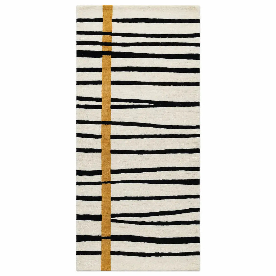 A rectangular area rug with a modern abstract pattern featuring horizontal black brushstroke lines on an off-white background, accented by a vertical mustard-gold stripe.