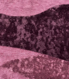 Abstract pattern with shades of purple and pink on a textured background
