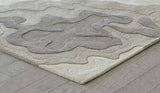 Arcadia Bloom hand-tufted rug with abstract neutral beige and gray patterns on wooden floor