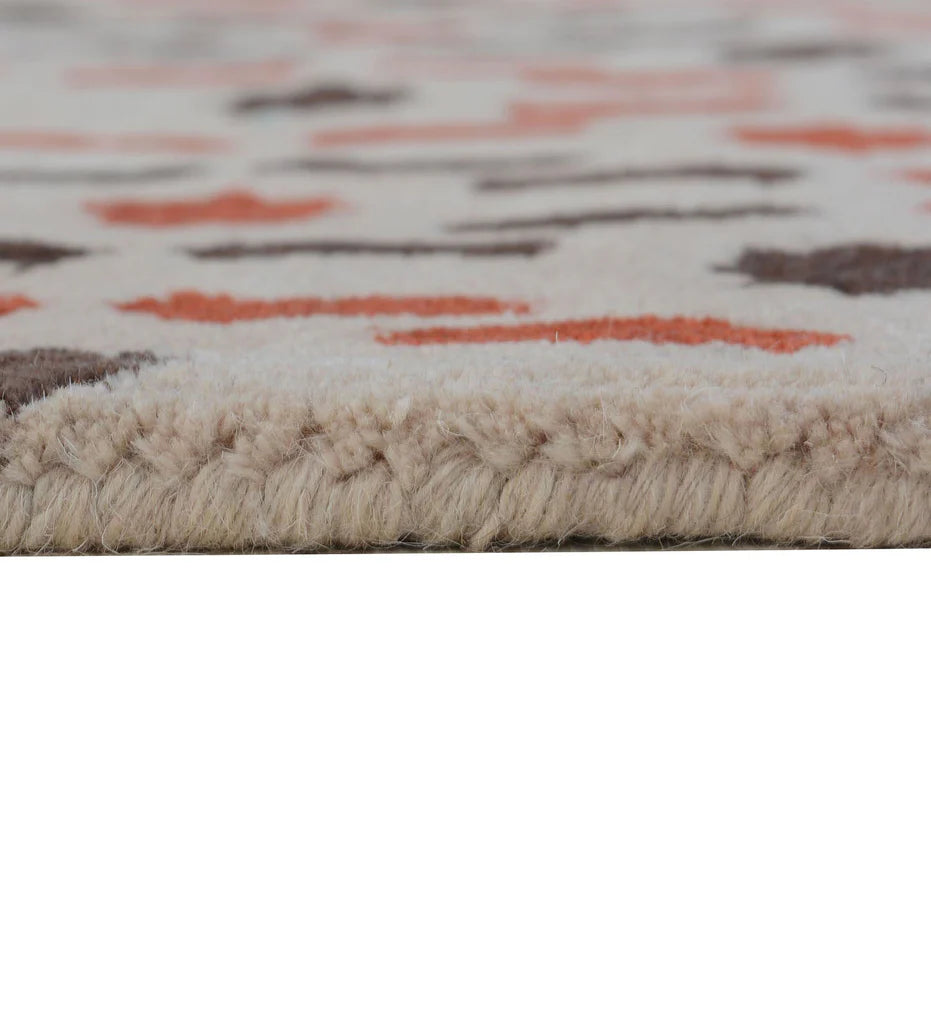 Artisan hand-tufted rug in beige with orange and brown detailing