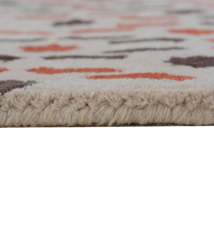 Artisan hand-tufted rug in beige with orange and brown detailing