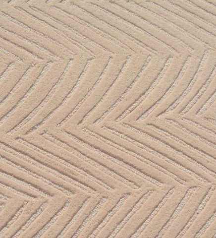 Minimalist beige rug with subtle chevron texture.