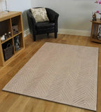 Beige textured chevron pattern rug on wooden floor in modern living room with black armchair and wooden shelves