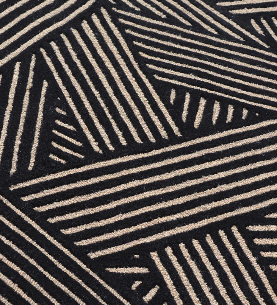 Modern black wool rug with beige linear weave pattern.