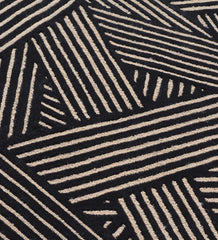 Modern black wool rug with beige linear weave pattern.