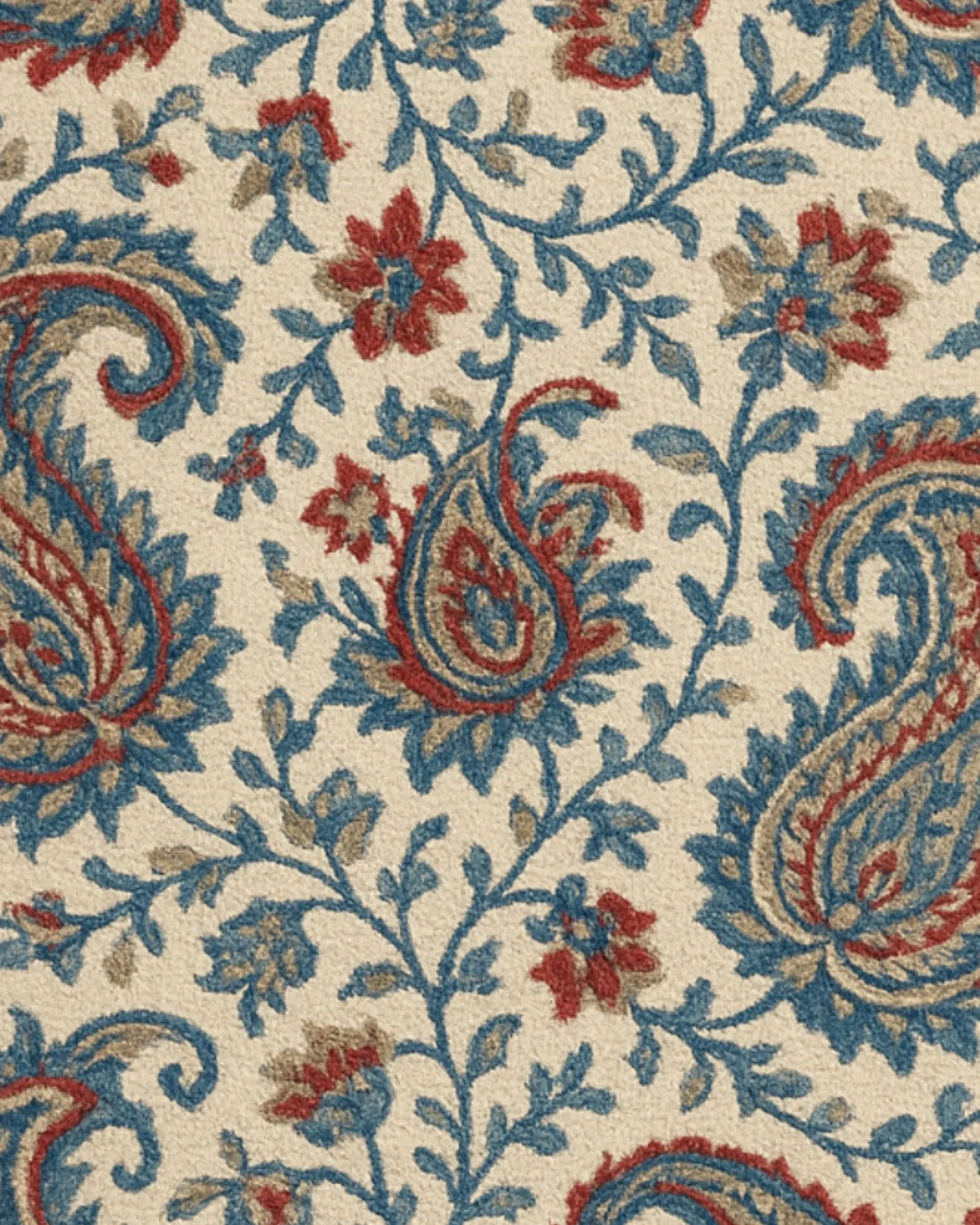 Hand-tufted wool rug with beige background and blue paisley design.