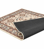 Beige and brown traditional area rug with floral patterns and black non-slip backing folded at corner