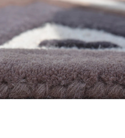 Geometric wool rug with beige, brown, and navy starburst design
