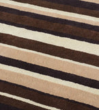 Modern hand-tufted area rug in beige, brown, and ivory tones.