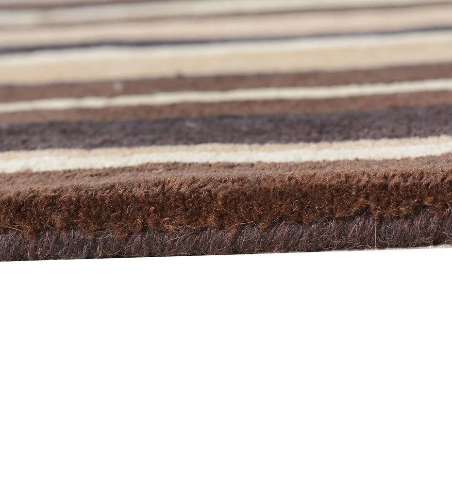 Hand-tufted wool rug with warm beige and brown linear pattern.