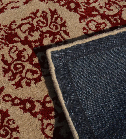 Heritage-inspired hand-tufted wool rug in beige and red